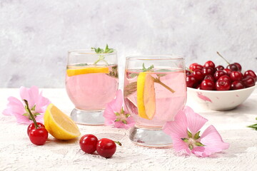 Cherry iced tea or mint and lemon cocktail, a refreshing summer drink recipe. Glass with apple...