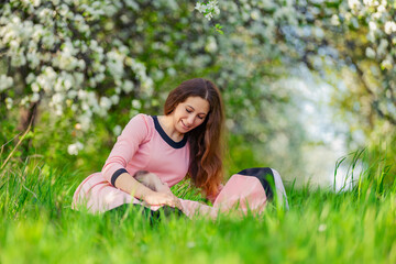 mother and daughter sit outdoors in a blooming garden
