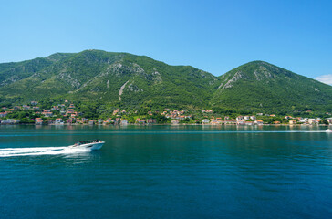 yacht trip in the Bay of Kotor, Montenegro, bright sunny day, mountains and palm trees, travel