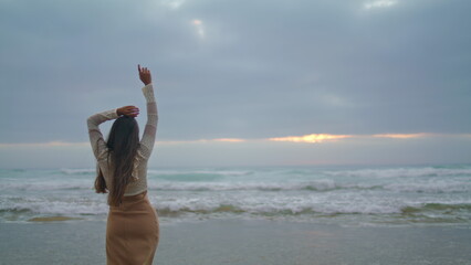 Sexy woman stepping sensually evening shore closeup. Unknown lady posing ocean
