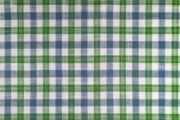 Green and blue checkered texture fabric, tartan pattern. Shirt fabric, tablecloth textile, linen plaid cloth, classic scottish check pattern. Backdrop, wallpaper, background.