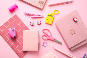 Different school stationery and notebooks on pink background