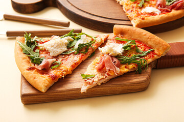 Slices of tasty pizza with Burrata cheese on yellow background