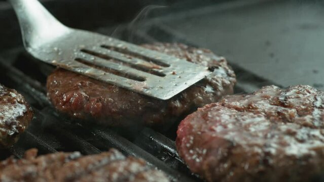 Hamburger on grill in slow motion