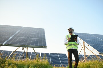 African american technician check the maintenance of the solar panels. Black man engineer at solar...