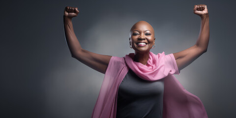 Beautiful bald woman fighting breast cancer, powerful woman and clasps her arms like a survivor.