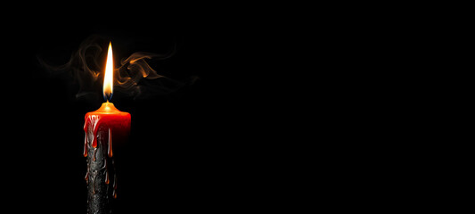 Candle with Smoke Burning in Dark Against Black Background