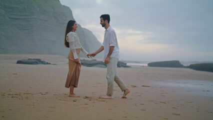 Romantic man proposing marriage to woman at beach. Couple celebrating engagement