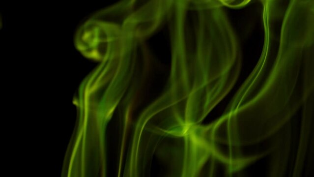 Abstract yellow green smoke on black background, slow motion video