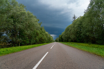 straight asphalt road and cloudy skies