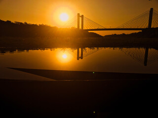 CUIABA bridge in river at sunset and sun
