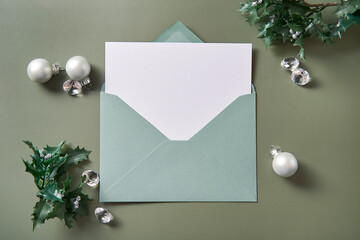 Christmas composition with an open envelope and blank white paper. Xmas mockup