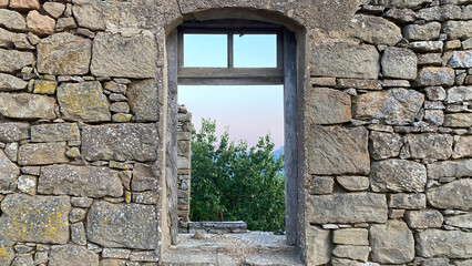 Ruined house wall and window in the Greek village of Tepeköy (Agridia), one of the most touristic places of Gökçeada - Turkish Aegean Island Gökçeada. Çanakkale, Turkey