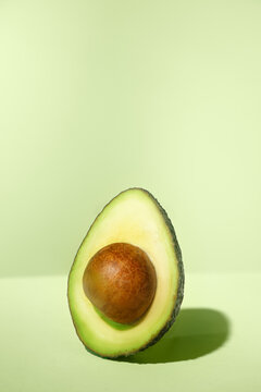 closeup cut of an avocado on a green surface