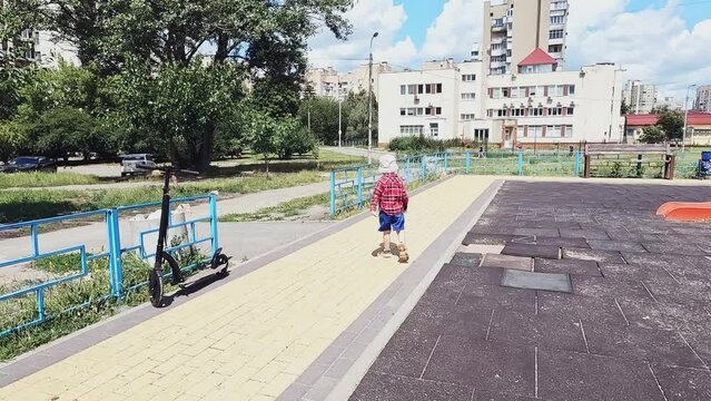 A little son runs away from his parents from the playground. Concepts of disobedience, prohibition, bad behavior, traffic rules, safety, freedom, kidnapping, looking for a child, punishment, walk