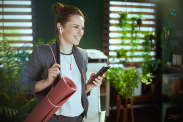 happy business woman in green office using phone