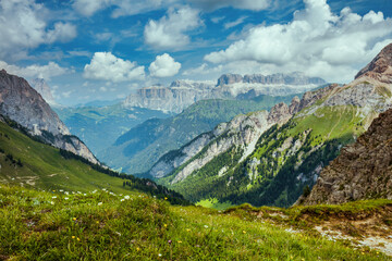 Fototapeta premium landscape with mountains, clouds and meadow