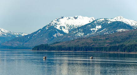 Whale Watching Boats Beneath Snow-Capped Mountians in Icy Strait, Alaska © dbvirago