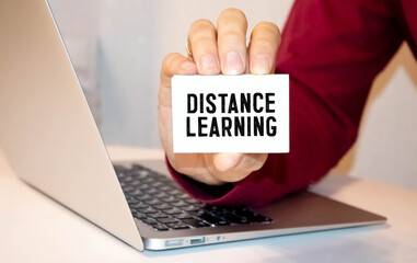 Blue distance learning button on white keyboard.