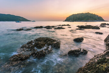 Beautiful sunset on the rock beach.