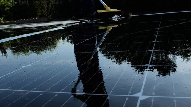 Cleaning solar panels from dust and dirt.fast motion .Solar Panel Efficiency.solar power technology.renewable energy.Alternative natural energy sources. 4k footage