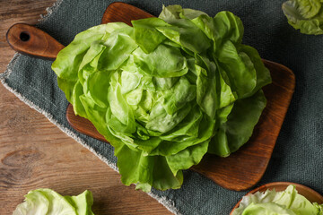 Fresh green butter lettuce on wooden table, flat lay - obrazy, fototapety, plakaty