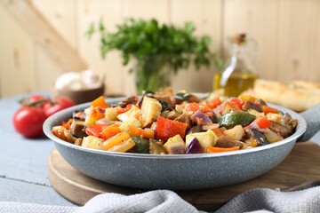 Delicious ratatouille in frying pan on grey table, closeup. Space for text