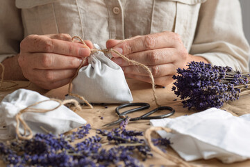 Woman tying a string on diy lavender sachet