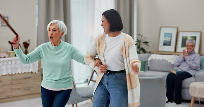 Dancing, senior woman and caregiver with happiness, music and freedom with retirement, energy or health. Female people, happy friends or ladies with movement, celebration or wellness in a living room