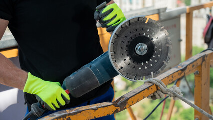 The master uses a diamond blade at a construction site. 