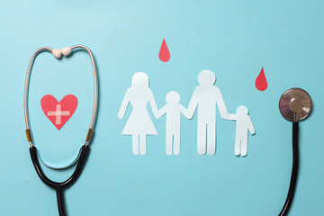 Family paper cut out with red heart paper, blood drop symbol and stethoscope as symbol of World...