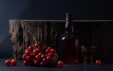 Whiskey and whiskey glass and bunch of grapes