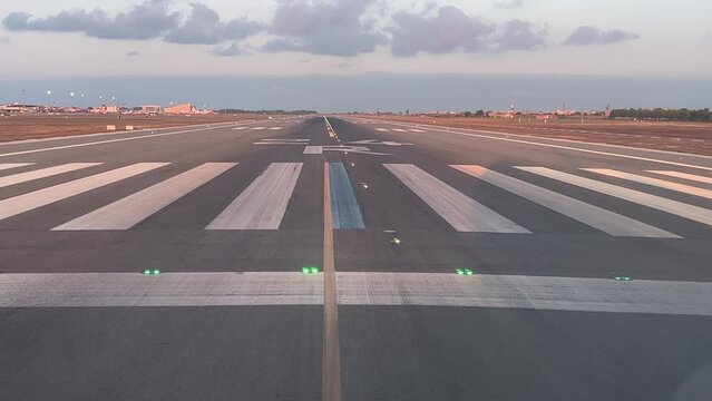 Take off run of a medium size jet taking off from Runway 24 just before sunset, with the shadow of the plane on the right side. A pilot&rsquo;s point of view from cockpit.