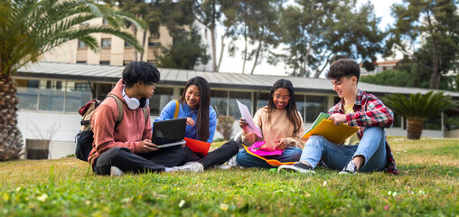 Multiracial college students doing university research homework and study together sitting on...