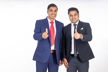 Two indian businessman showing thumps up.