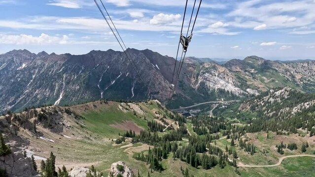 Summer ski tram recreation snowbird mountain Utah descending. Summer and winter all season mountain resort. Vacation nature family fun destination. Recreation rides.