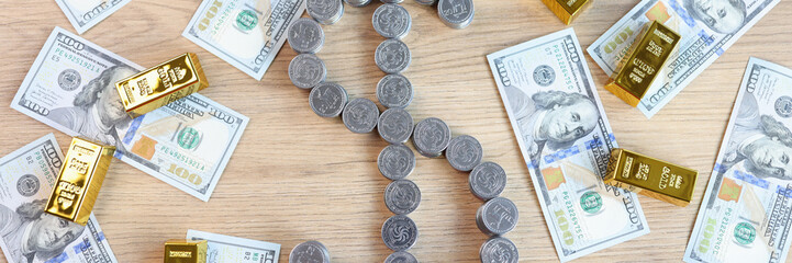 Coins in shape of dollar symbol and a lot of gold bars with US dollar bills on table, top view.