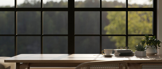 Copy space on a wooden table against the window in a comfortable room.