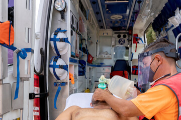 Lifeguard attending to an injured person with an oxygen tank