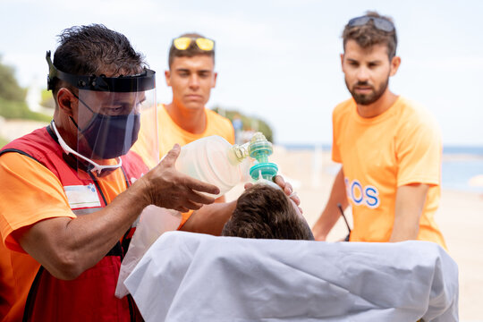 Doctors attending to an injured person on the beach