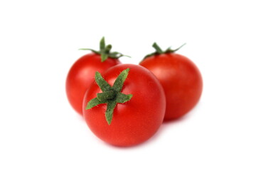 Three red tomatoes lie on a white background.