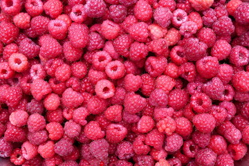 Texture of ripe red juicy raspberries.