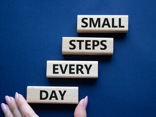 Small Steps Every Day symbol. Wooden blocks with words Small Steps Every Day. Beautiful deep blue background. Businessman hand. Business and Small Steps Every Day concept. Copy space.