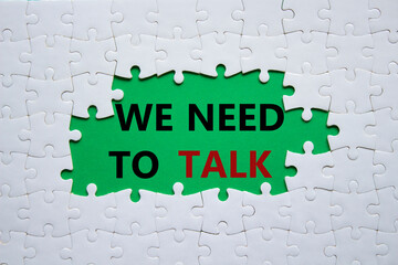 We need to talk symbol. Concept words We need to talk on white puzzle. Beautiful green background. Business and We need to talk concept. Copy space.