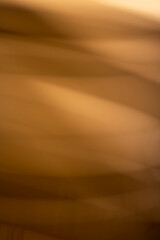 Abstract golden background, wallpaper of a elegant gold smooth wavy segments, photography design.
