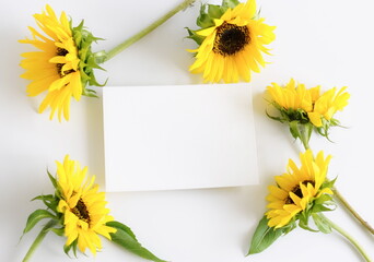 Card mockup and sunflowers bouquet  top view on white background flatlay. copy space. Blank, greeting card template.