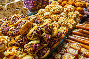 Turkish sweets with hazelnuts, almond and nougat. Sweets and traditional oriental delights concept. Street bazaar, Istanbul, Turkey