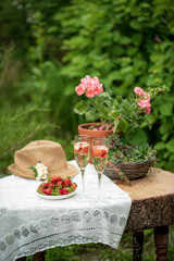 Fototapeta na wymiar champagne with fresh strawberries in garden