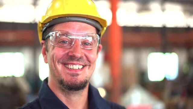 Good looking caucasian white professional factory worker portrait in footage.