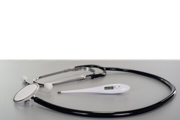 stethoscope envelope white modern thermometer on gray table with copy space background